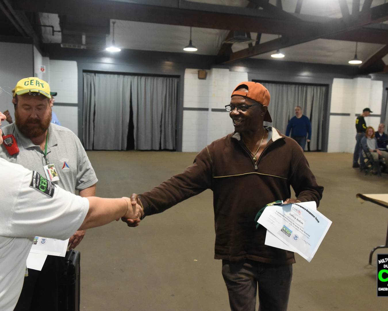 CERT Graduate Shaking Hands with CERT Leaders after graduating